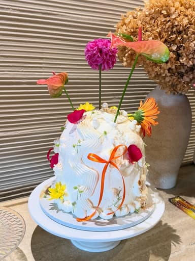 White dome cake decorated with fresh flowers